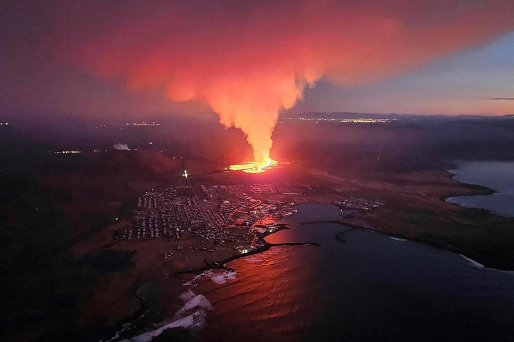 In this photo provided by Civil Protection taken from the Icelandic Coast Guard's helicopter, a view of lava as the volcano erupts near Grindavík, Iceland, Sunday, Jan. 14. 2024.
