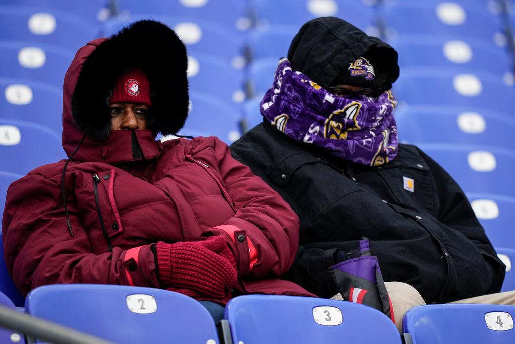 Fans watch teams warm up before an NFL football AFC divisional playoff game between the Baltimore Ravens and the Houston Texans