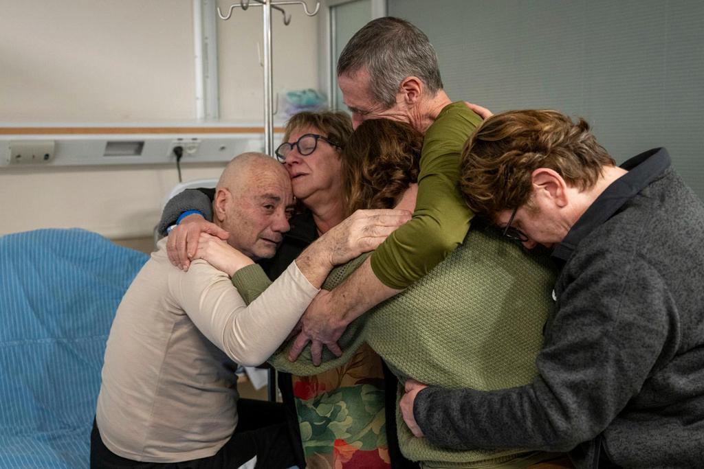 Hostage Luis Har, left, is hugged by relatives after being rescued from captivity in the Gaza Strip, at the Sheba Medical Center in Ramat Gan, Israel