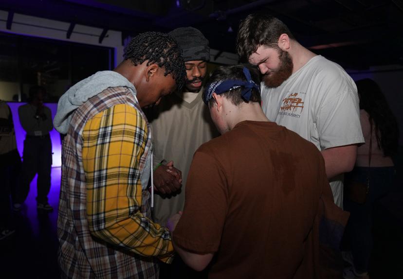 Young clubbers at The Cove, a pop-up, 18-and-up Christian nightclub, pray together after a night of dancing 