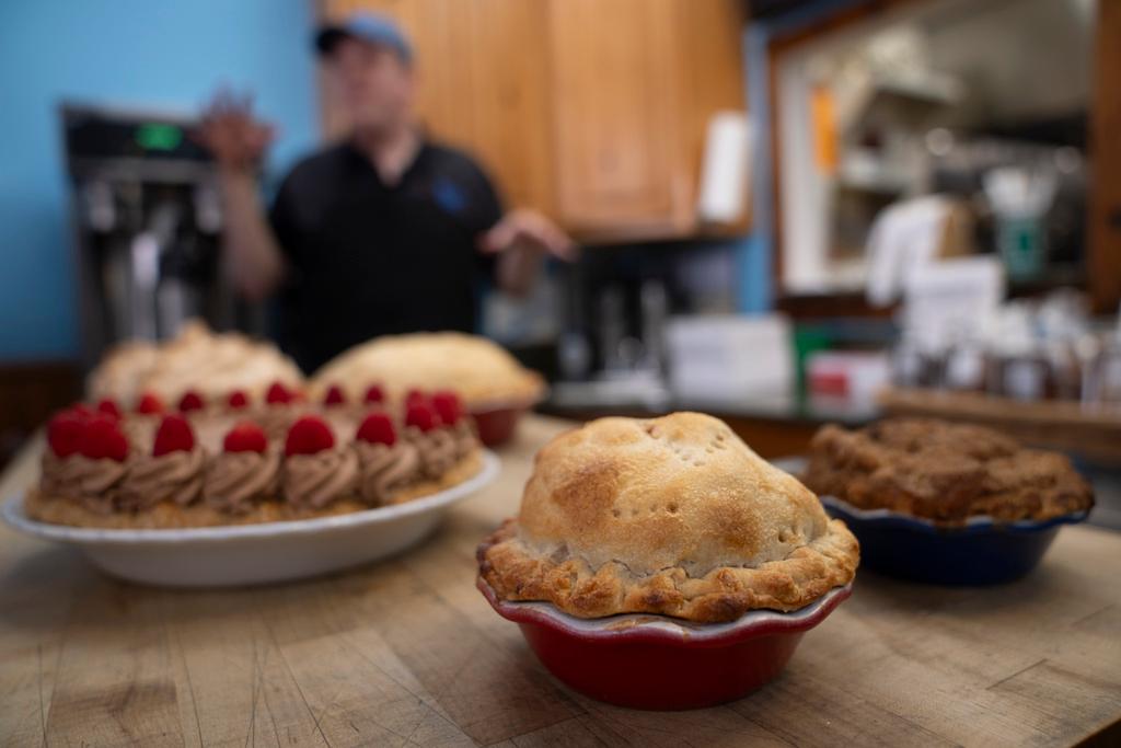 Manager Stephen Jarrett prepares pies on a counter at Michele's Pies, Wednesday, March 13, 2024, in Norwalk, Conn.