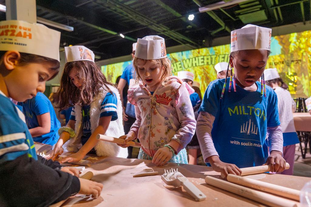 Hana Chmeruk, center, who moved to the U.S. from Ukraine, and Avigael Yahyisrael, 7, make matzah with other first graders from Milton Gottesman Jewish Day School of the Nation's Capital, during a "Matzah Factory" field trip to the JCrafts Center for Jewish Life and Tradition in Rockville, Md.
