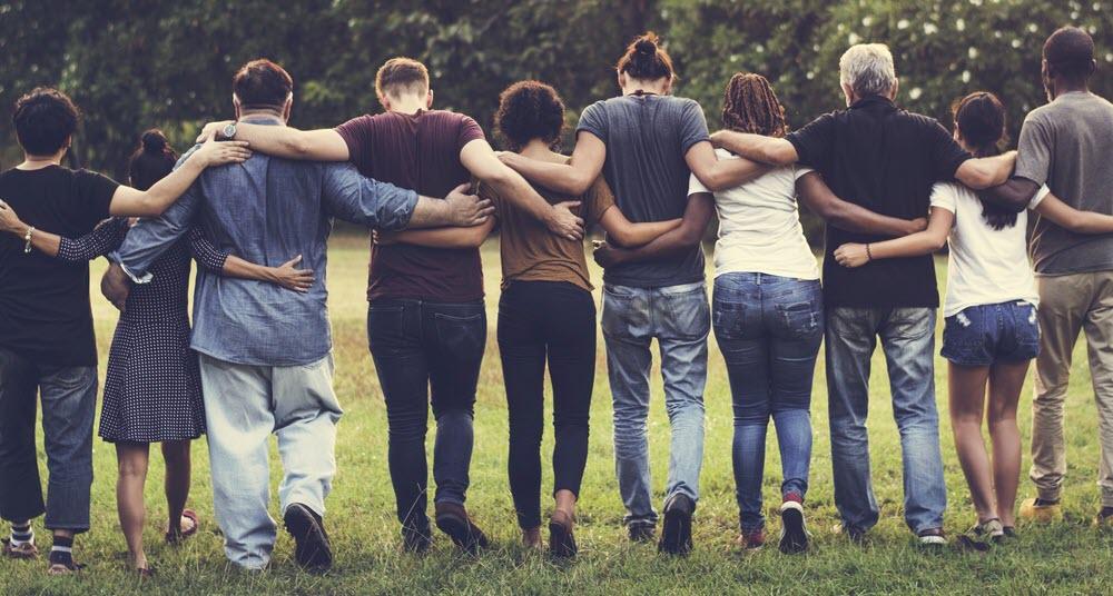 Group of people in a linked in a link with their arms on each other's backs
