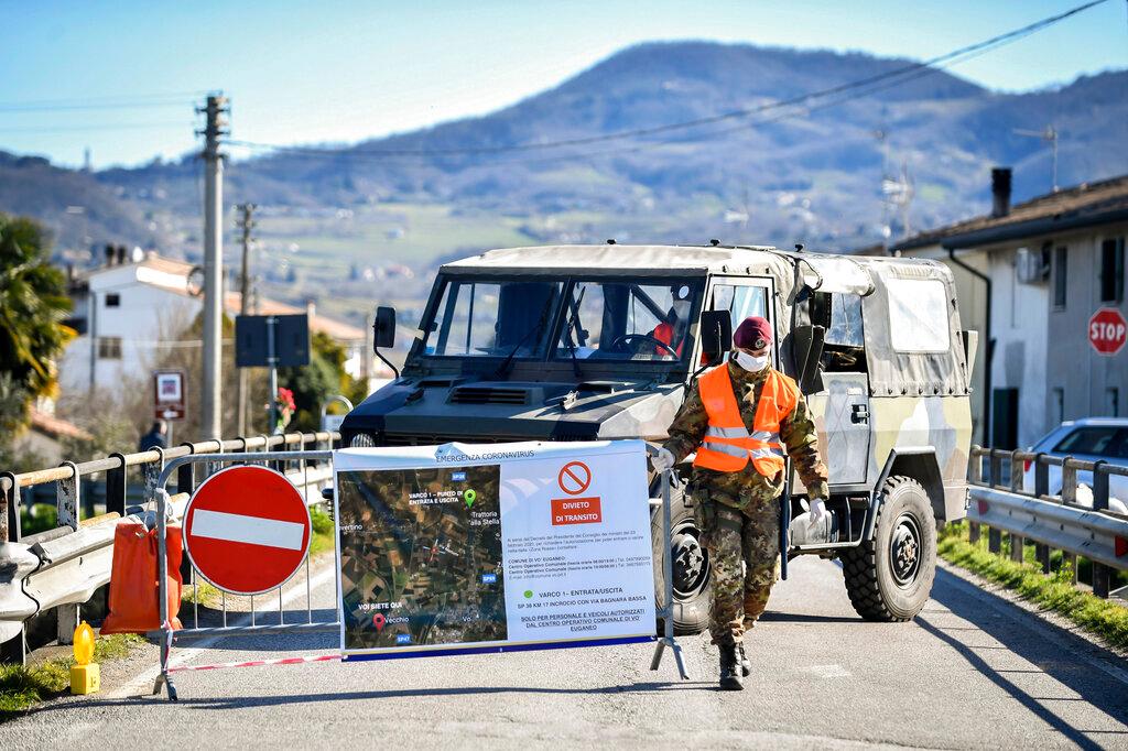 An Italian army soldier blocks off a road leading to the village of Vo'Euganeo, in Italy's northern Veneto region - the epicenter of the Veneto cluster of the new virus