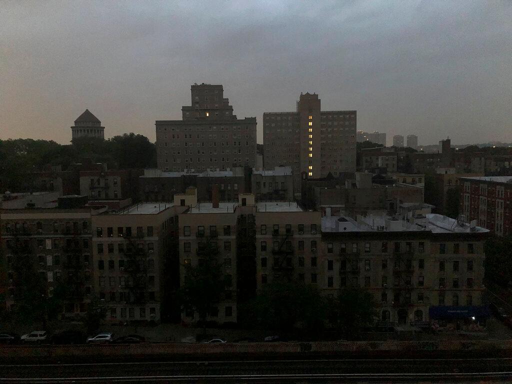 Buildings in Harlem sit dark during a power outage early, Friday, Aug. 7, 2020, in New York. A power outage cast darkness across dozens of blocks in New York City as many people in the city were still without electricity in the aftermath of Tropical Storm Isaias. Con Edison said that a problem with its transmission system "caused three networks in Manhattan to lose their electric supply," just after 5 a.m.