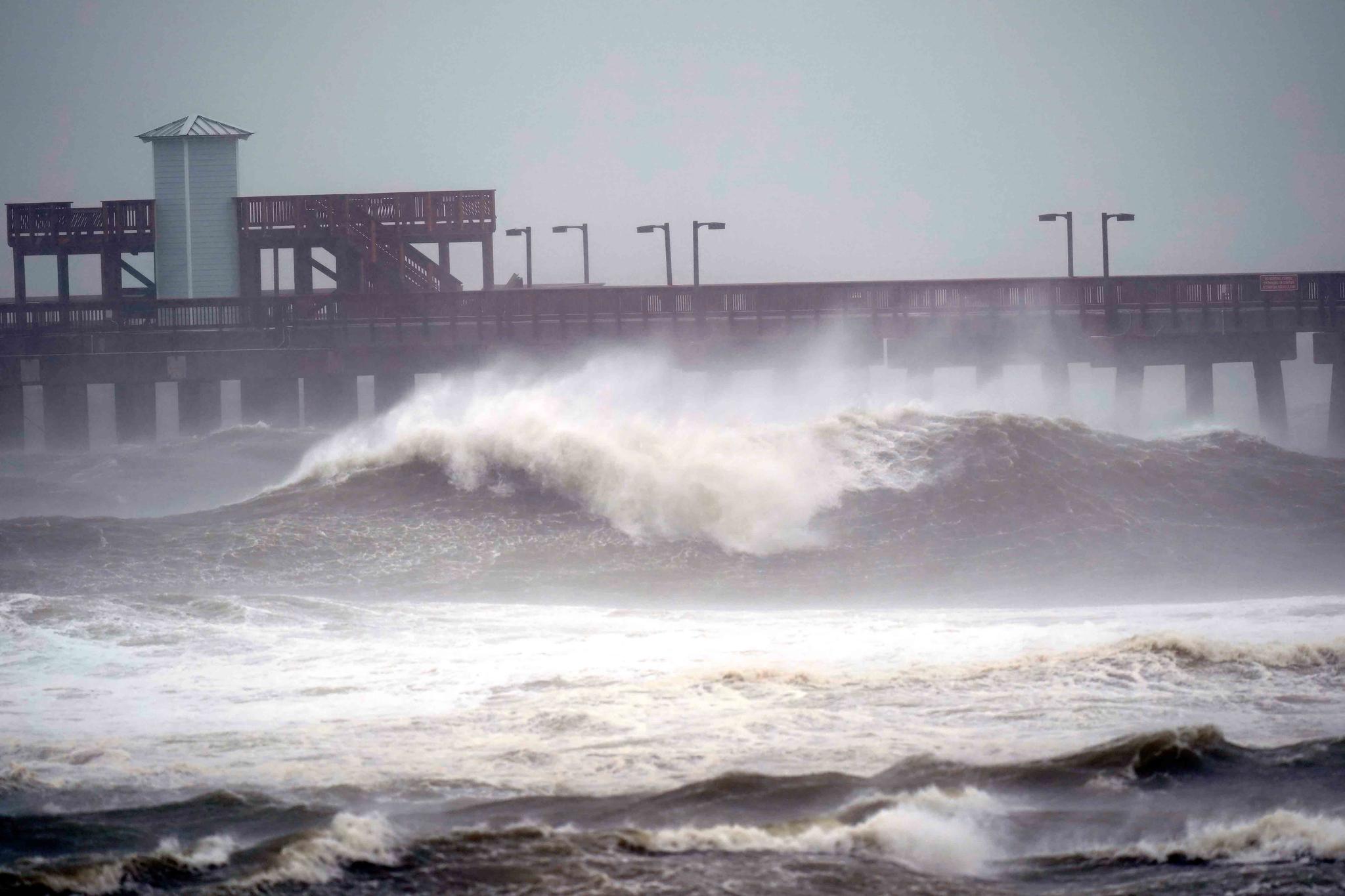 Waves crash near a pier, at Gulf State Park, Tuesday, Sept. 15, 2020, in Gulf Shores, Ala. 