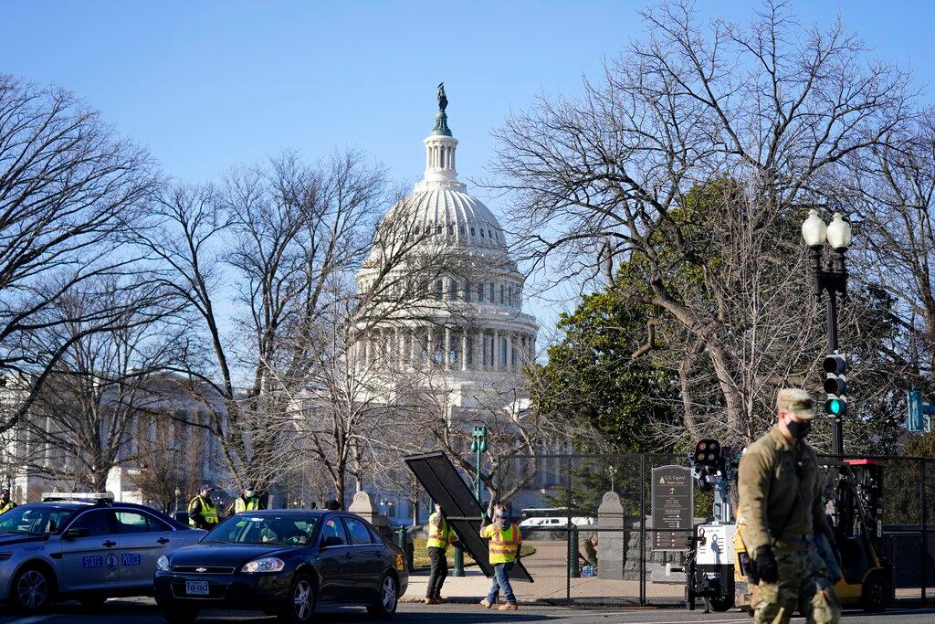 Workers install no-scale fencing at the US Capitol 