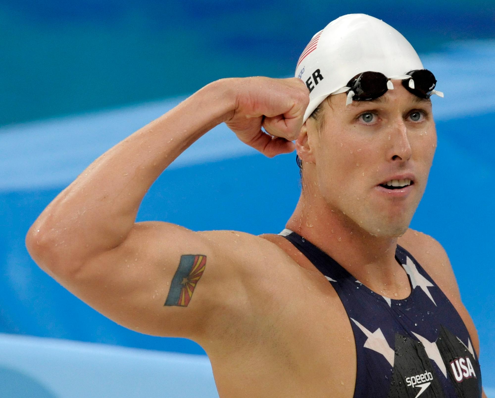 Olympic Swimming Medalist Klete Keller flexing bicep