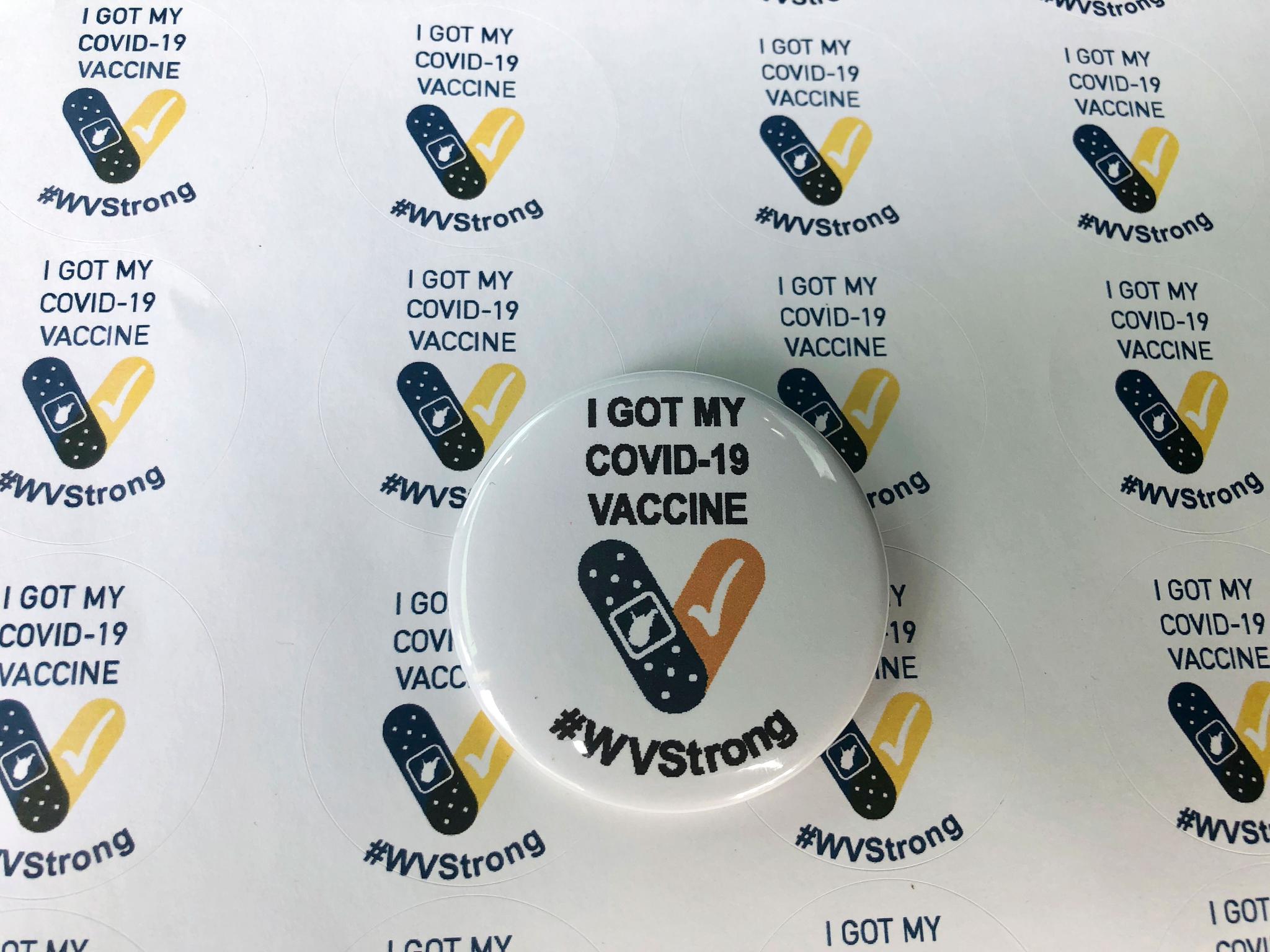 Stickers and a button given to people who receive their COVID-19 vaccines in West Virginia