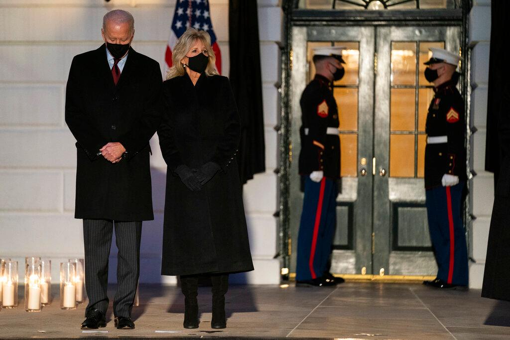 President Joe Biden and first lady Jill Biden participate in a moment of silence during a ceremony to honor the 500,000 Americans that died from COVID-19