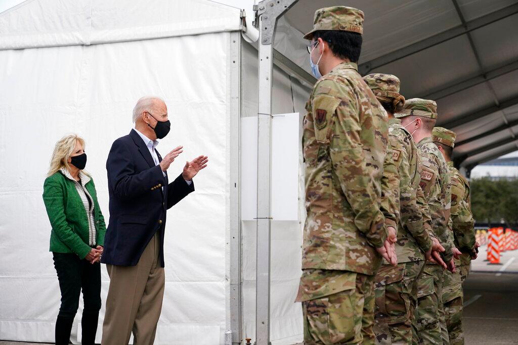 President Joe Biden and first lady Jill Biden meet with troops at a FEMA COVID-19 mass vaccination site at NRG Stadium in Houston