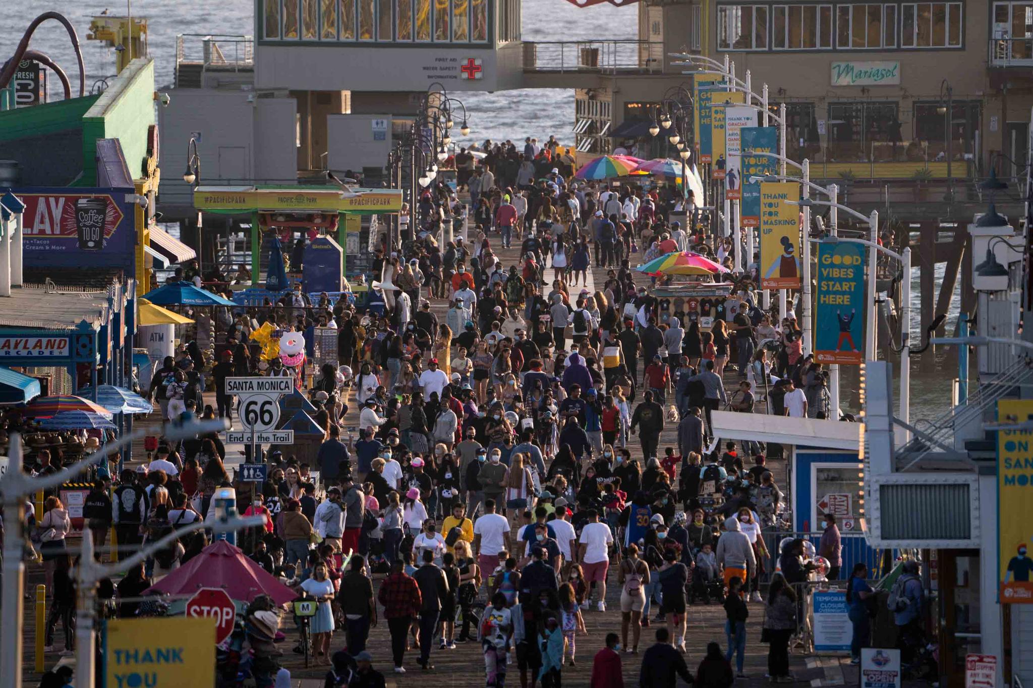 people gather on the Santa Monica Pier in Santa Monica, Calif. 
