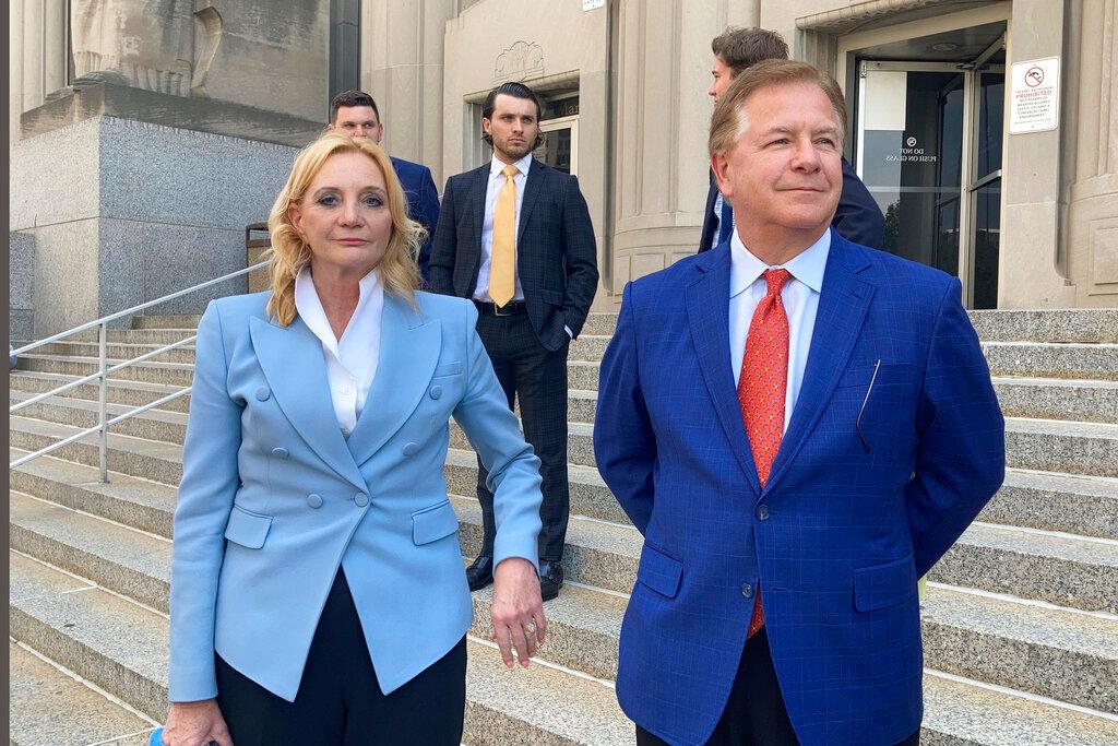 Patricia McCloskey, left, and her husband Mark McCloskey leave a court in St. Louis