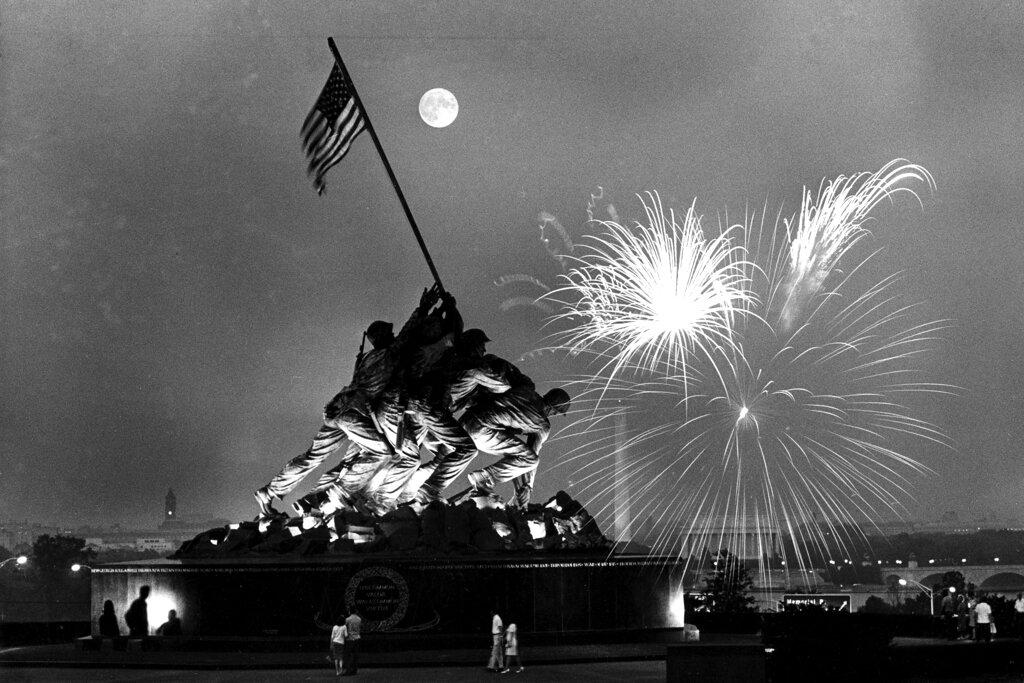 United States Marine Corps War Memorial, which depicts a scene from Iwo Jima, as fireworks burst over Washington
