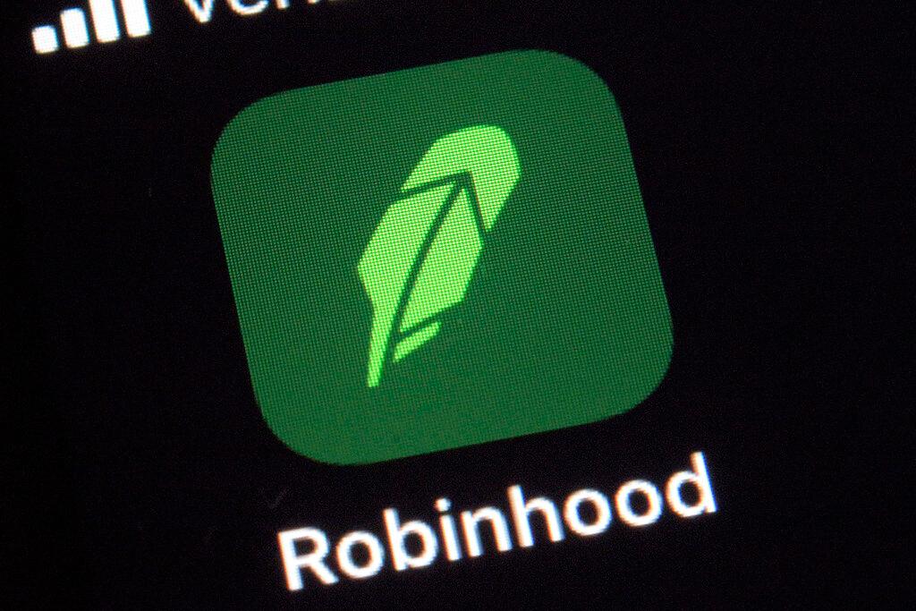 This Dec. 17, 2020 photo shows the logo for the Robinhood app on a smartphone in New York. Robinhood Financial will pay a $57 million fine and return another $12.6 million to thousands of its customers to settle accusations of a wide range of supervisory failures, such as hurting customers by giving them misleading information and improperly allowing some to make riskier trades.