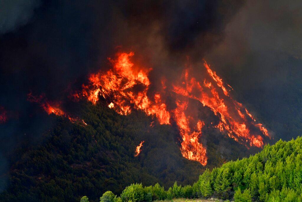Flames burn a mountain in Platanos village, near ancient Olympia, western Greece
