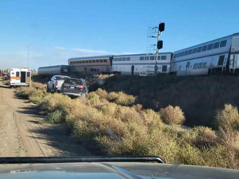 In this photo provided by Kimberly Fossen an ambulance is parked at the scene of an Amtrak train derailment on Saturday, Sept. 25, 2021, in north-central Montana.