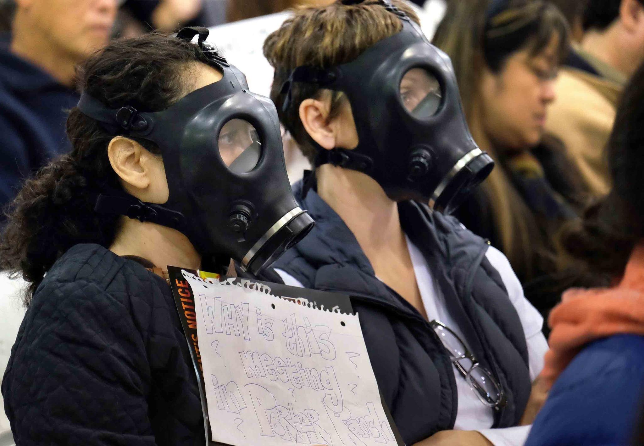 In this Jan. 16, 2016, file photo, protesters wearing gas masks, attend a hearing over a gas leak at the southern California Gas Company's Aliso Canyon Storage Facility near the Porter Ranch section of Los Angeles.