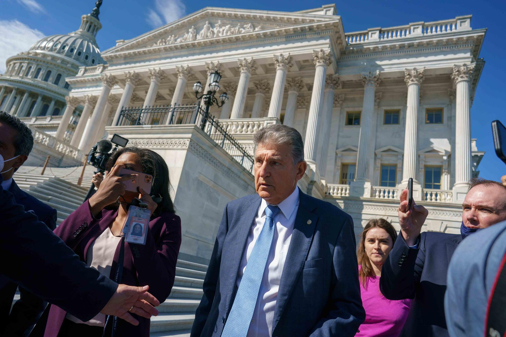 Sen. Joe Manchin, D-W.Va., a centrist Democrat vital to the fate of President Joe Biden's $3.5 trillion domestic agenda, is surrounded by reporters outside the Capitol in Washington, Wednesday, Sept. 29, 2021.