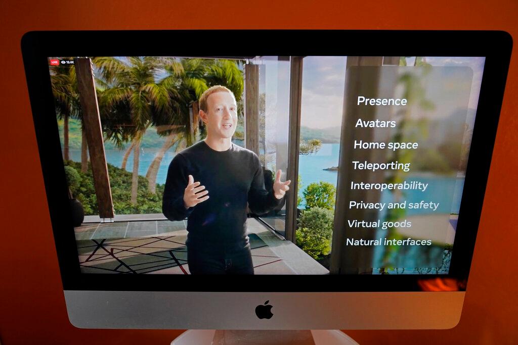 Seen on the screen of a device in Sausalito, Calif., Facebook CEO Mark Zuckerberg delivers the keynote address during a virtual event