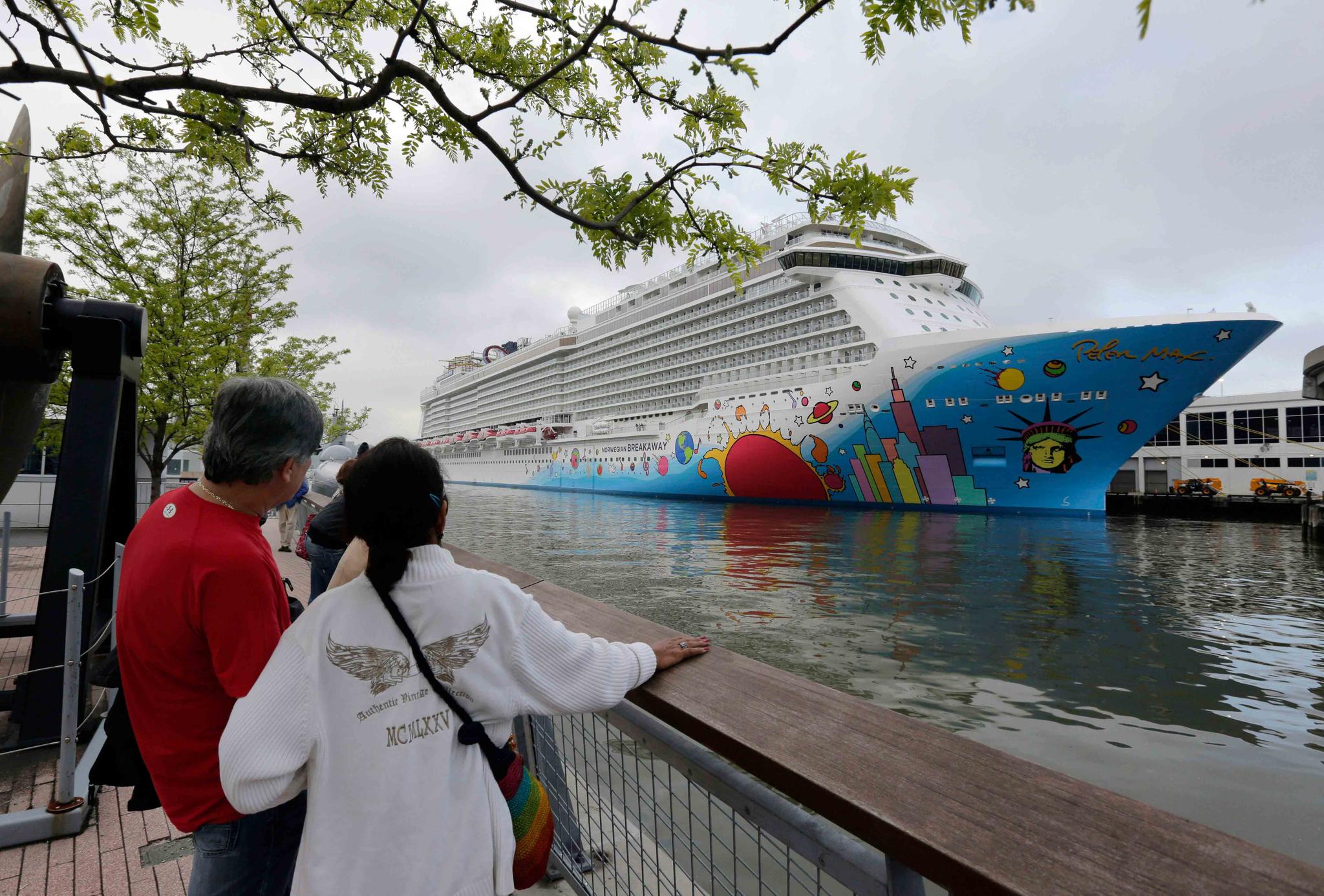 People pause to look at Norwegian Cruise Line's ship, Norwegian Breakaway, on the Hudson River, in New York, on May 8, 2013.