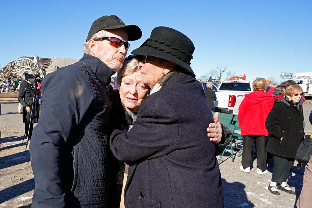Arthur Byrn, left; Carole Dowdy, center; and Carla McDonald console each other after an outdoor service was held at First Christian Church Sunday, Dec. 12, 2021, in Mayfield, Ky. 