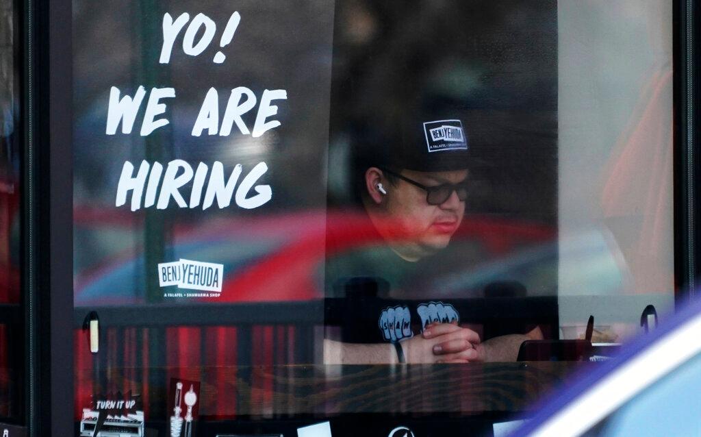 A hiring sign is displayed at a restaurant in Schaumburg, Ill.