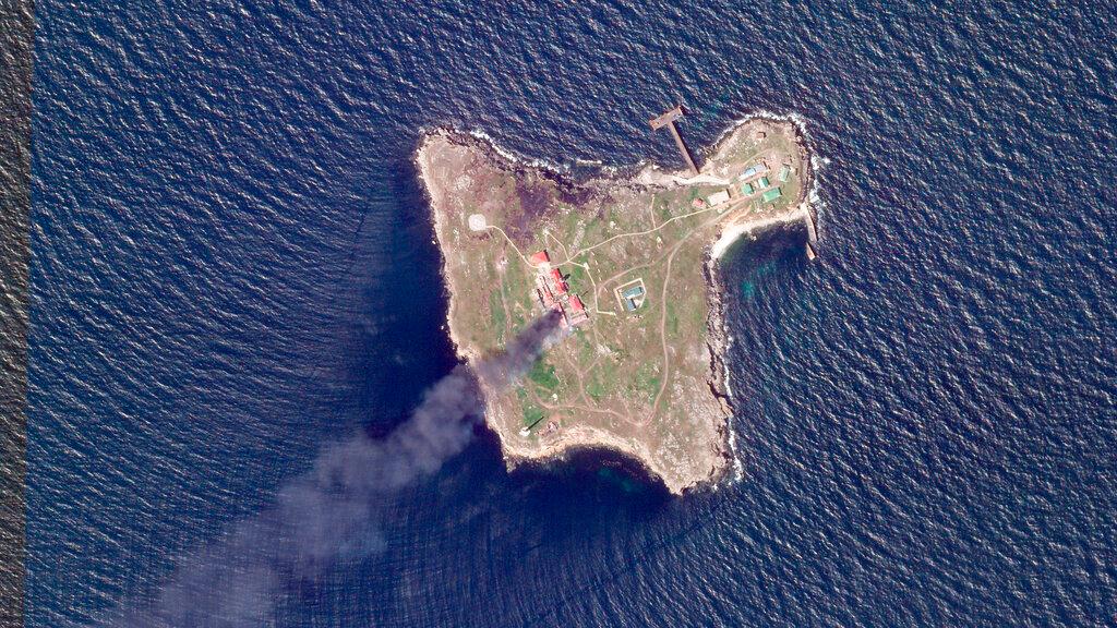 This satellite image taken by Planet Labs PBC shows thick black smoke rising after a suspected Ukrainian drone strike on Russian positions on Snake Island, Ukraine, in the Black Sea Friday, May 6, 2022.