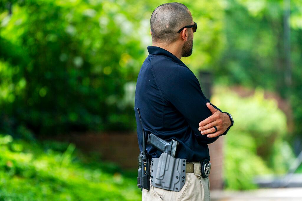 A U.S. Marshal patrols outside the home of Supreme Court Justice Brett Kavanaugh, in Chevy Chase, Md.