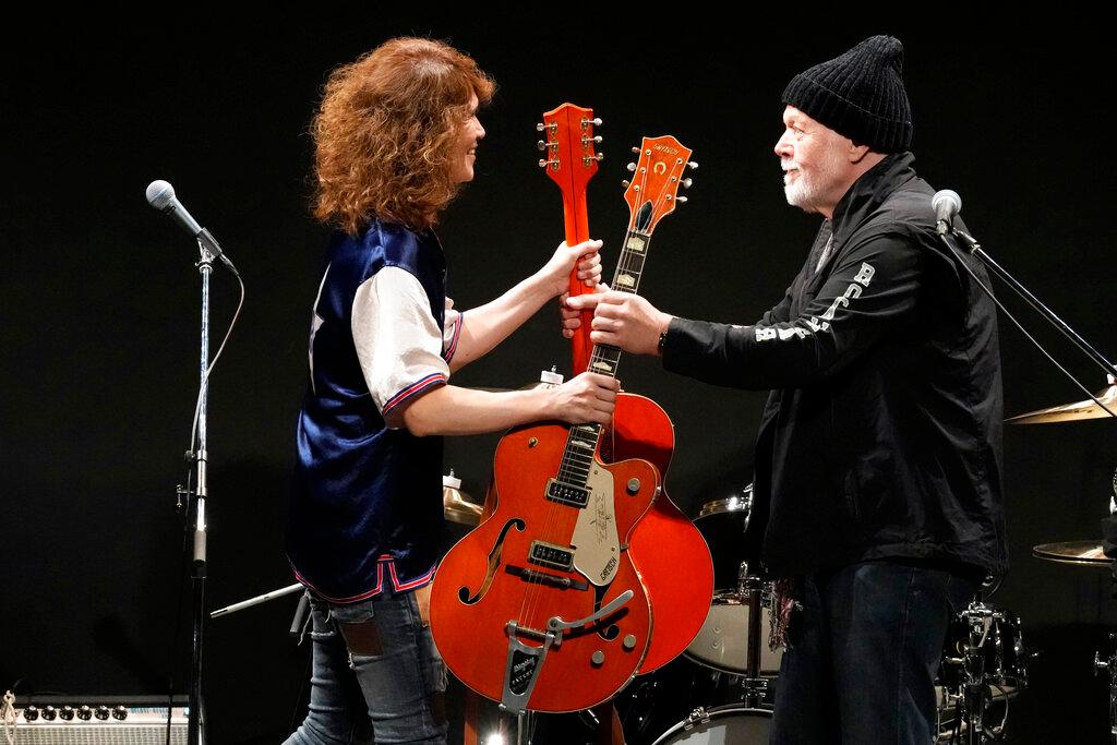 Randy Bachman and  musician exchange guitars