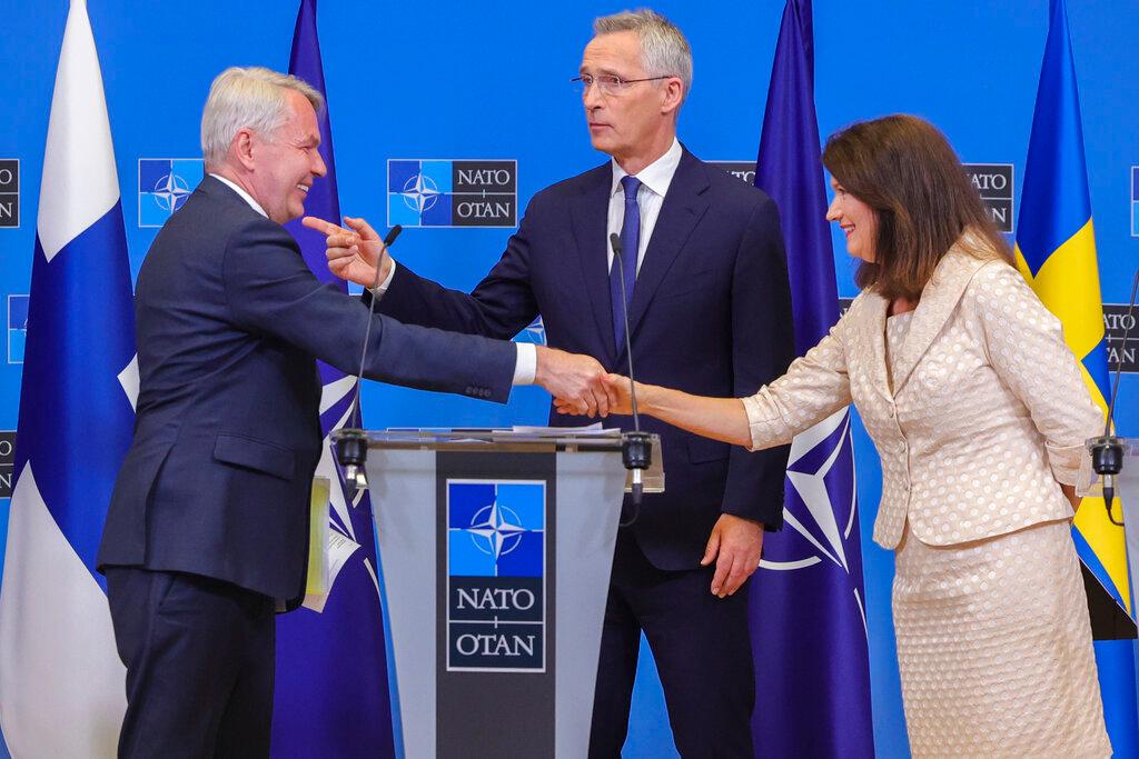 Finland's Foreign Minister Pekka Haavisto, left, Sweden's Foreign Minister Ann Linde, right, and NATO Secretary General Jens Stoltenberg