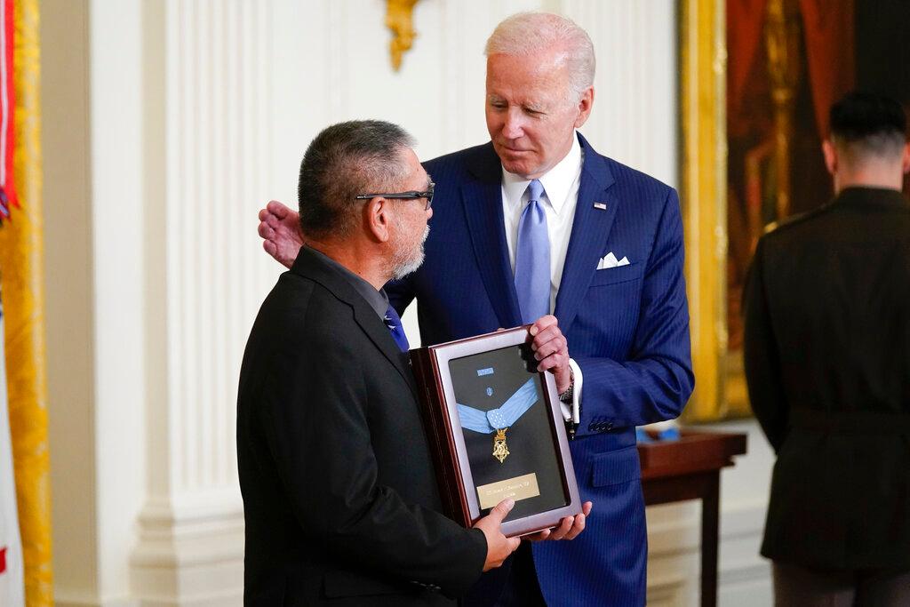 President Joe Biden presents the Medal of Honor to Staff Sgt. Edward Kaneshiro for his actions on Dec. 1, 1966, during the Vietnam War, as his son John Kaneshiro accepts the posthumous recognitionduring a ceremony in the East Room of the White House