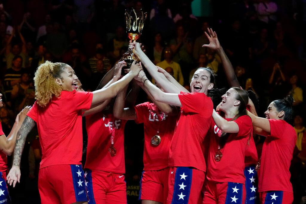 Gold medalists the United States hold their trophy aloft as they celebrate on the podium after defeating China in the final at the women's Basketball World Cup in Sydney, Australia, Saturday, Oct. 1, 2022.