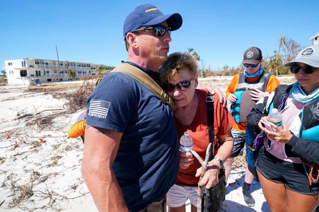 Resident Judy Hicks is embraced by Project DYNAMO rescuer Bryon Wheeldon, before she is taken off the island, in the wake of Hurricane Ian