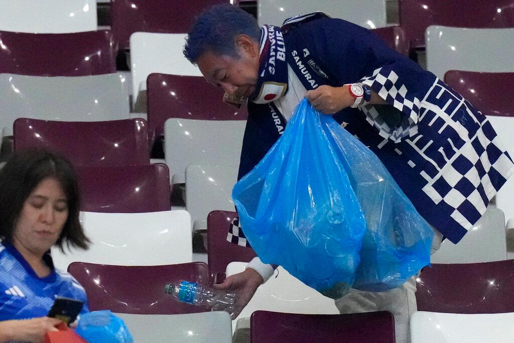 Japan supporters clean the stands