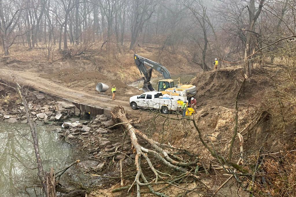 Washington County Road Department constructs an emergency dam to intercept an oil spill.