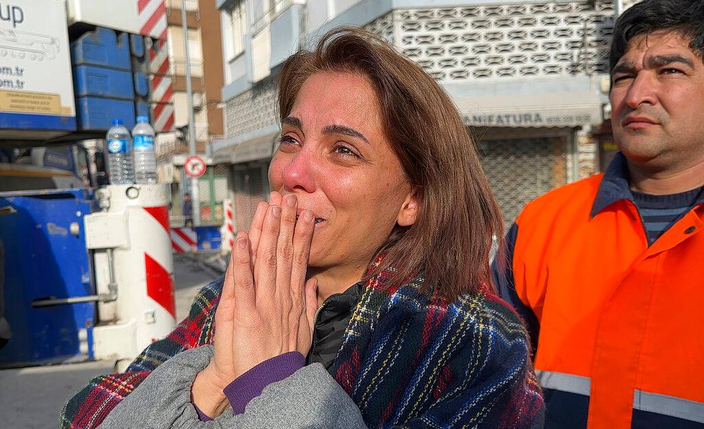 Woman reacts while watching rescue works in Iskenderun, southern Turkey