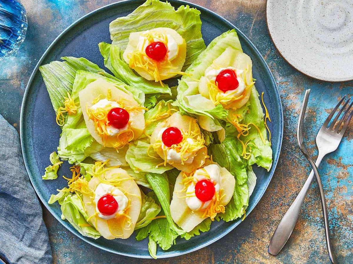 Cold pear and maraschino cherry salad on iceberg lettuce