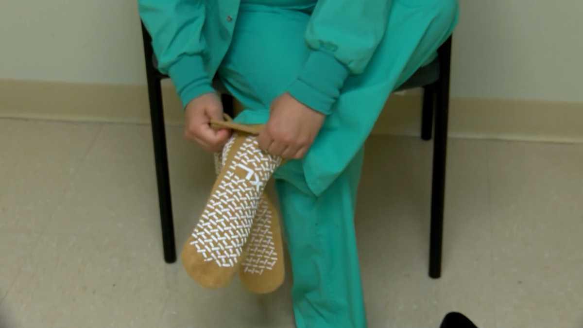 Nurse putting on patient socks