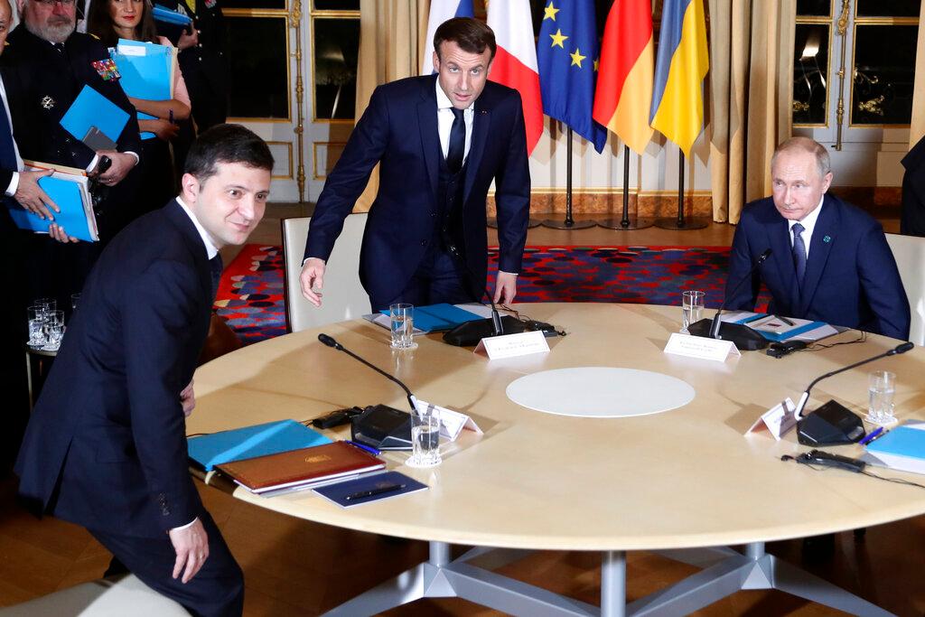French President Emmanuel Macron, center, Russian President Vladimir Putin, right, and Ukrainian President Volodymyr Zelenskiy, left