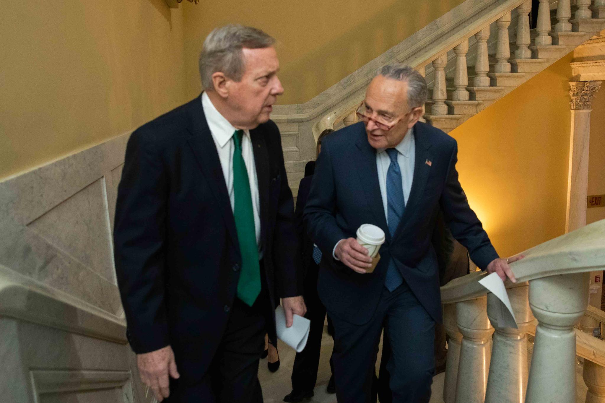 Democratic leader Sen. Chuck Schumer, D-N.Y., right, and Sen. Dick Durbin, D-Ill., walk on the steps in the U.S. Capitol on the first full day of the impeachment trial of President Donald Trump on charges of abuse of power and obstruction of Congress in Washington